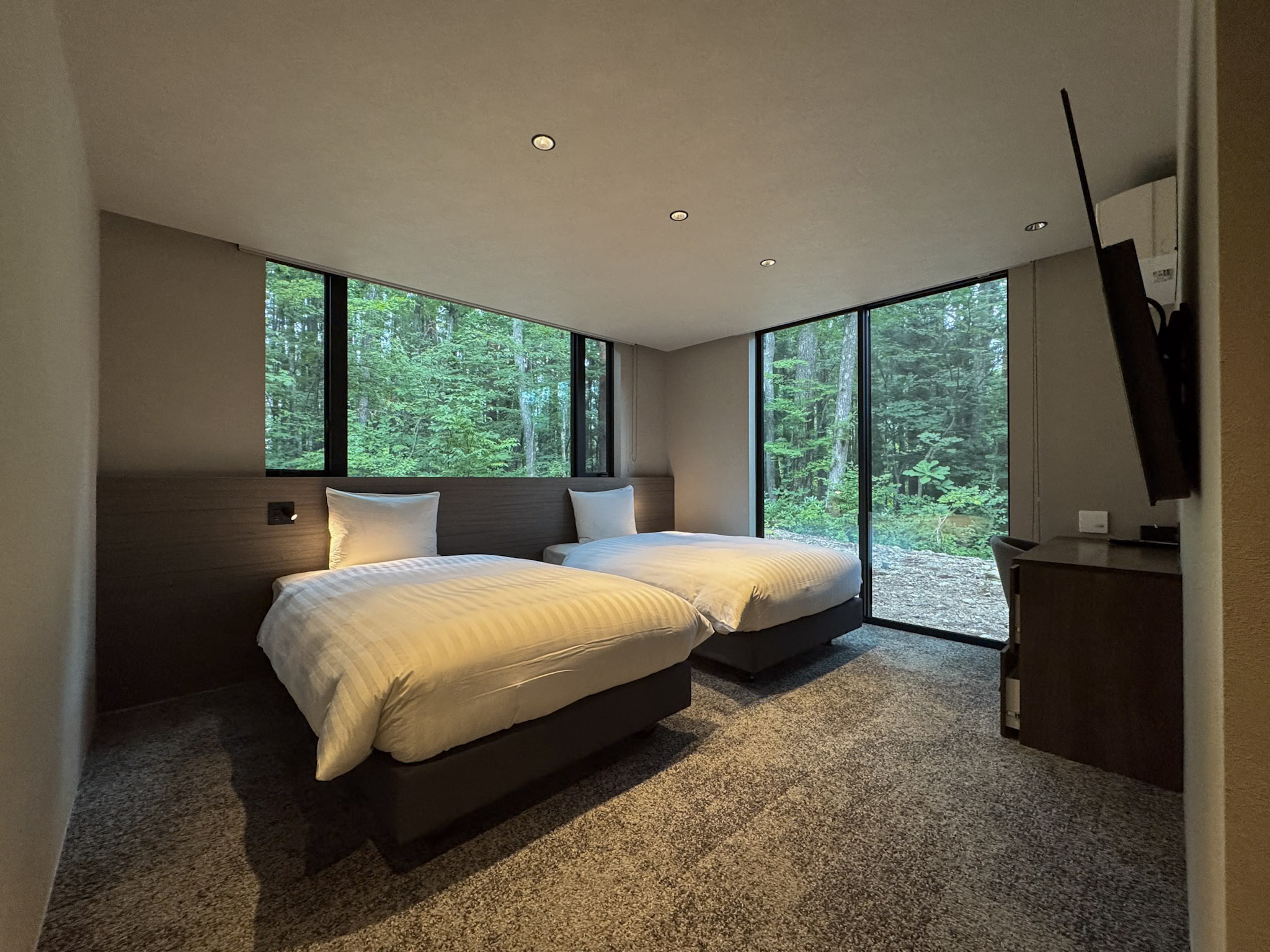 Bedroom 1 with two semi-double beds and forest views